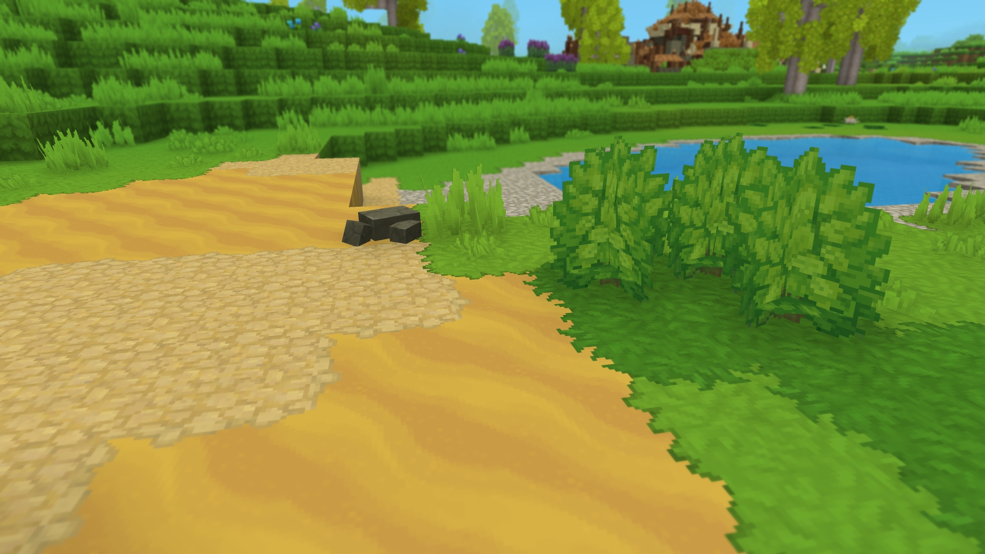 Крупный план местности с переходными текстурами, плавно смешивающими блоки травы, песка и гравия